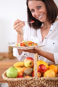 Woman eating fruit salad