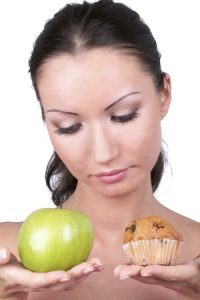 Woman contemplating fruit or cake