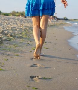 Woman barefoot walking beach